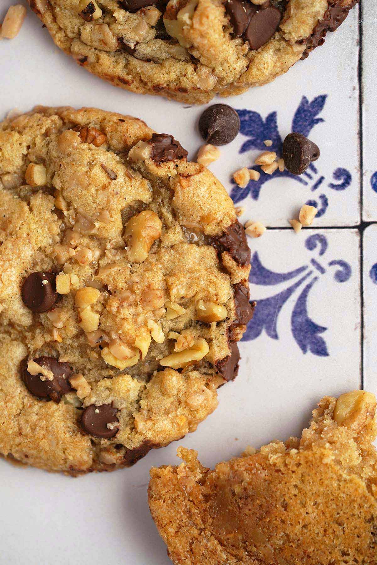 top view of sourdough toffee cookies with chocolate chips on old white tile